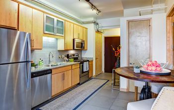 a kitchen with stainless steel appliances and a wooden table